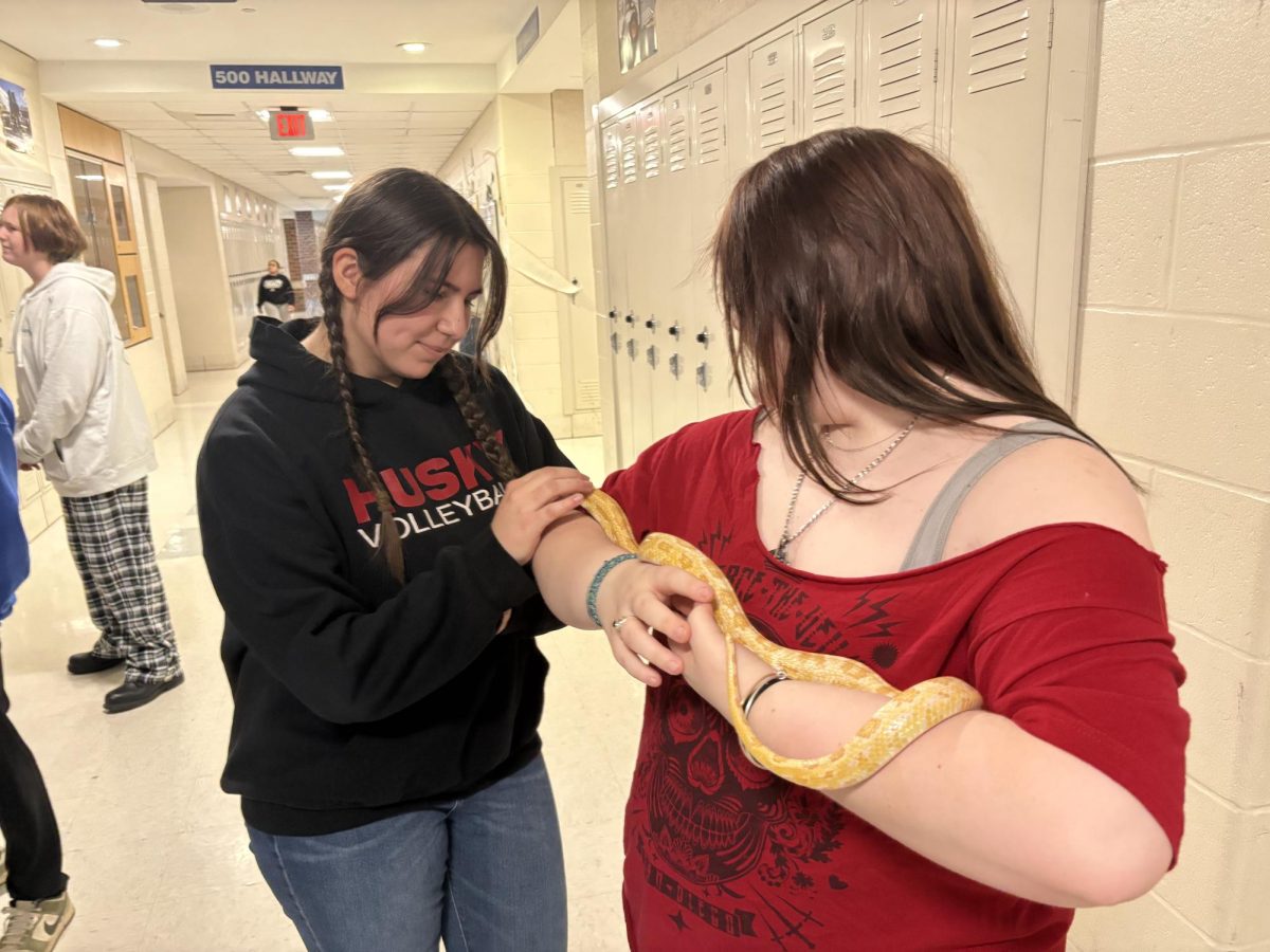 Kai Skorupski (left) and Kai LaValley (right) with Butters the snake