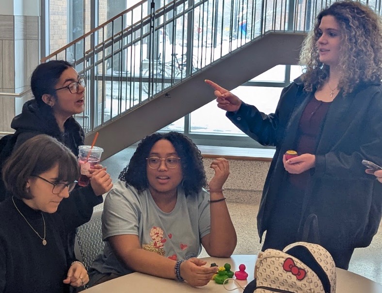 Senior MaryKate Mormino and juniors Gia Gonzalez, Elianna Vega and Rebekah Urquhart discuss strategies while playing the "Duck for a Buck" competition.