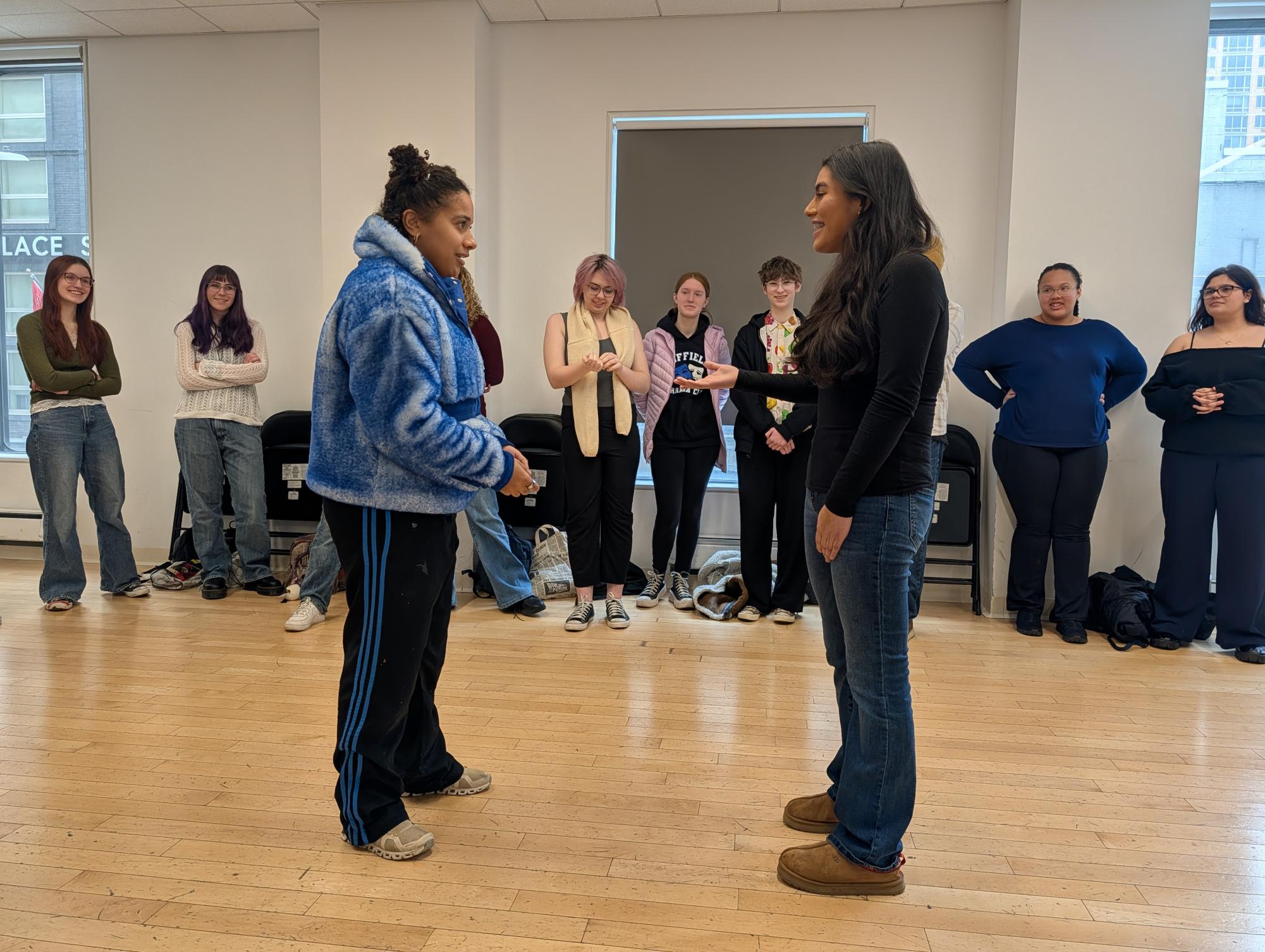Broadway actress Ayla Ciccone-Burton works with freshman Diana Castillo on an acting exercise to help with energy